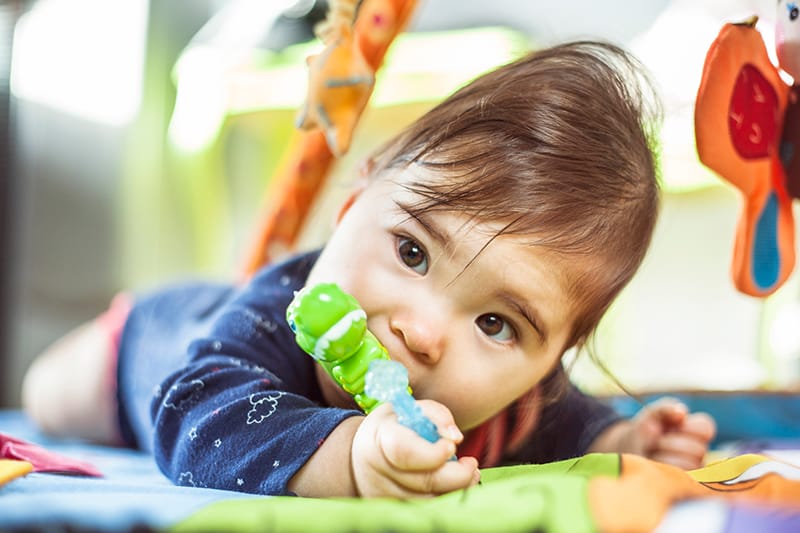 Baby chewing on teething toy