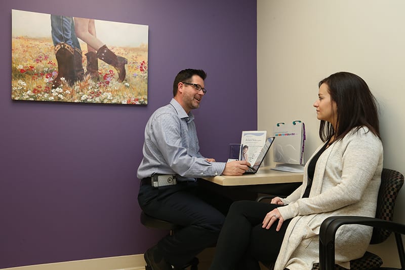 Physican and female patient having a conversation in doctors office