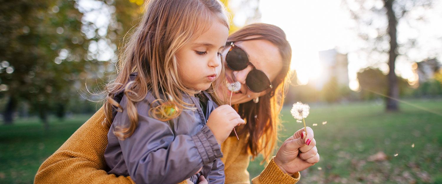 Girl blowing dandelion