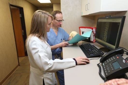 nurse and doctor looking at computer