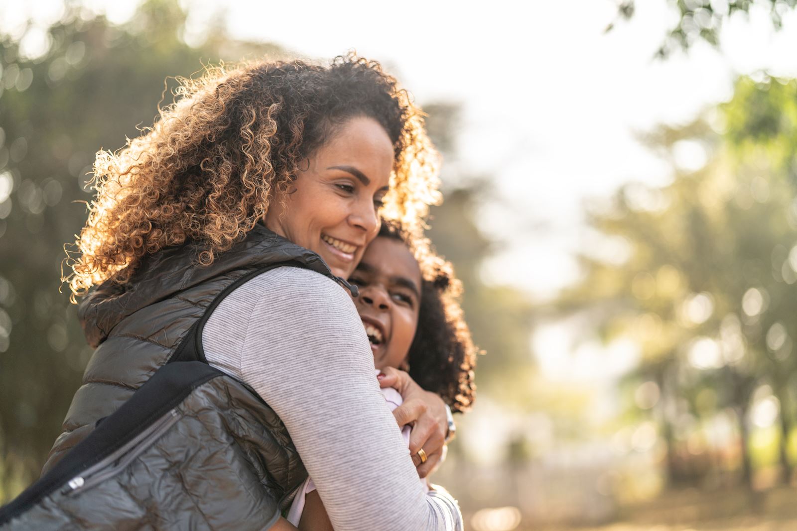 mother and daughter hug outside