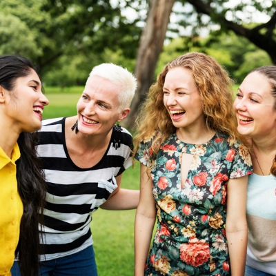 women smiling and laughing at each other