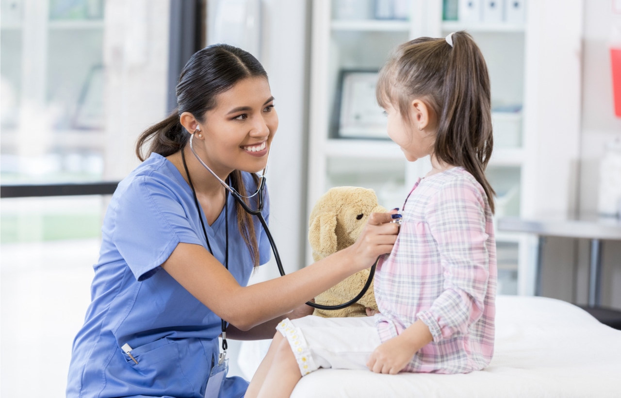 Woman listening to child's heart