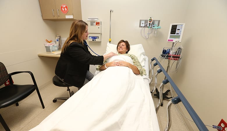 Endoscopy Center - doctor checking vitals of patient in bed before procedure