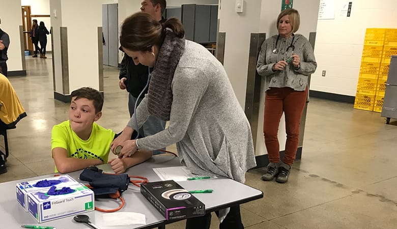 young male having blood pressure checked